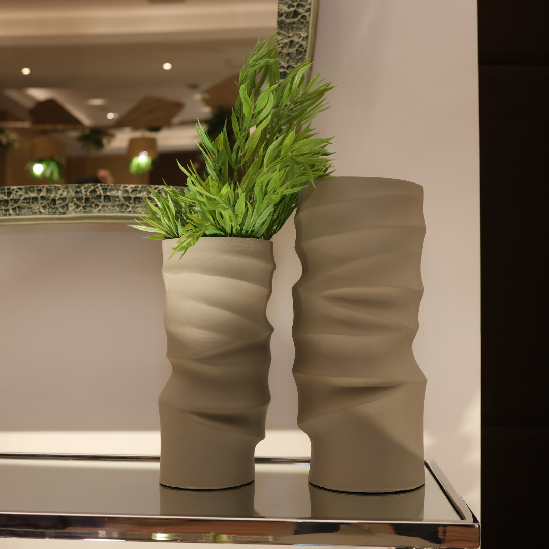 Decorative plant pot with wavy design on a reflective surface