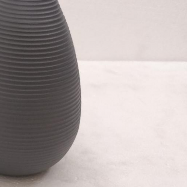 Gray textured vase on a light gray background