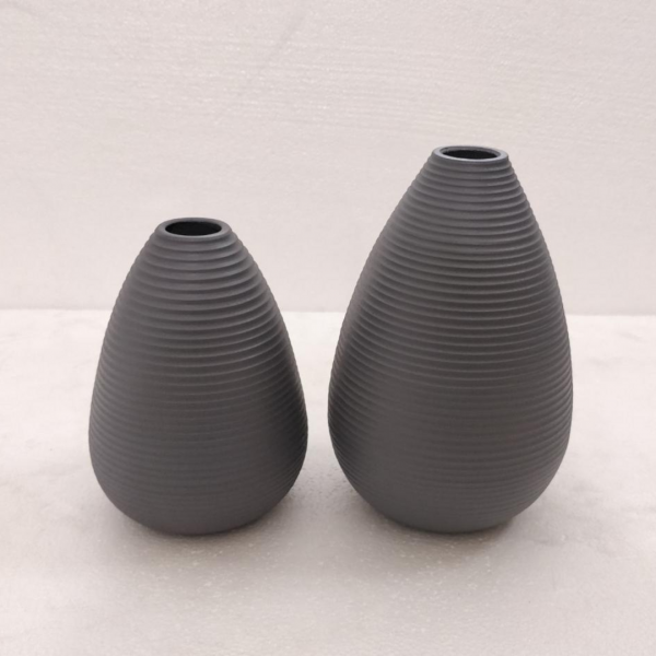Two gray textured vases on a light gray background